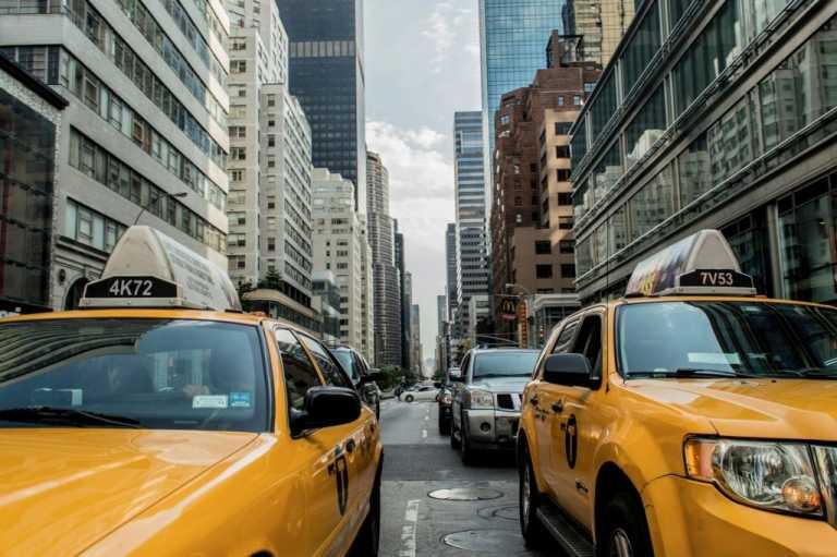Taxi cabs driving down the street