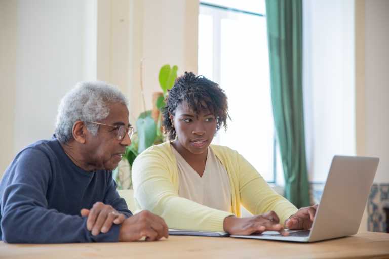 Two people looking at a computer