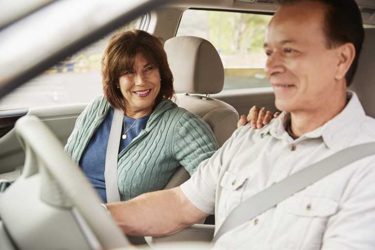 woman passenger smiling at the driver during car JZUKCWG 1